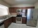 Modern kitchen with stainless steel appliances and granite countertops at 9521 Grovedale Cir # 201, Riverview, FL 33578