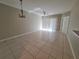 Spacious living room with tile flooring and sliding glass doors at 9521 Grovedale Cir # 201, Riverview, FL 33578