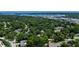 An aerial view of the property showcasing the lush green surroundings, neighborhood, and the nearby waterfront at 963 27Th S Ave, St Petersburg, FL 33705