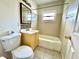 Bathroom with yellow vanity and tub at 963 27Th S Ave, St Petersburg, FL 33705