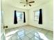 Bright bedroom featuring tile floors, ceiling fan, and two windows at 963 27Th S Ave, St Petersburg, FL 33705