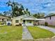 Nice yellow house with a carport and lawn at 963 27Th S Ave, St Petersburg, FL 33705