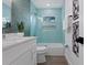 Modern bathroom with a tiled shower/tub combo, updated fixtures, and stylish decor at 2203 Avenue B, Bradenton Beach, FL 34217