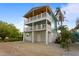 Two-story house with light blue siding, two balconies, and a two-car garage at 2203 Avenue B, Bradenton Beach, FL 34217