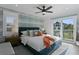 Comfortable main bedroom with a plush bed, calming wall decor, and private balcony access at 2203 Avenue B, Bradenton Beach, FL 34217