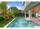 Relaxing pool area with lounge chairs and a grassy area at 2203 Avenue B, Bradenton Beach, FL 34217