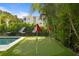 Landscaped backyard with putting green and lounge chairs at 2203 Avenue B, Bradenton Beach, FL 34217