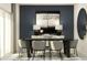 Elegant dining room with dark wood table, gray chairs, and artwork at 10024 Trumpet Honeysuckle Way, San Antonio, FL 33576