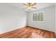 Simple bedroom with hardwood floors and a ceiling fan at 10525 Lucaya Dr, Tampa, FL 33647