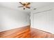 Bedroom with hardwood floors, double doors, and ceiling fan at 10525 Lucaya Dr, Tampa, FL 33647