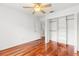 Hardwood floor bedroom with ceiling fan and large closet at 10525 Lucaya Dr, Tampa, FL 33647