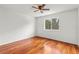 Hardwood floor bedroom with large window and ceiling fan at 10525 Lucaya Dr, Tampa, FL 33647