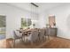 Bright dining room with hardwood floors and modern light fixture at 10525 Lucaya Dr, Tampa, FL 33647