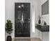 Modern entryway with black door, floating shelf, and decor at 10525 Lucaya Dr, Tampa, FL 33647