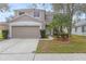 Two-story house with attached garage and landscaping at 10525 Lucaya Dr, Tampa, FL 33647