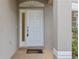 White front door with sidelight and decorative arch at 10525 Lucaya Dr, Tampa, FL 33647