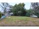 Large backyard with grassy lawn and mature trees at 11012 N Oregon Ave, Tampa, FL 33612