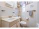 Simple bathroom with vanity, toilet, and window at 11012 N Oregon Ave, Tampa, FL 33612