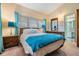 Bright bedroom with teal bedding and ensuite bathroom at 11012 N Oregon Ave, Tampa, FL 33612