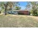 House exterior showcasing a light blue and brick home at 11012 N Oregon Ave, Tampa, FL 33612