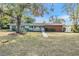 Ranch style home with brick facade and spacious lawn at 11012 N Oregon Ave, Tampa, FL 33612