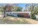 Ranch style home with light blue siding and brick accents at 11012 N Oregon Ave, Tampa, FL 33612