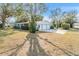 Ranch-style home with a two-car garage and mature landscaping at 11012 N Oregon Ave, Tampa, FL 33612