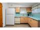 Retro kitchen with light blue countertops and wood cabinets at 11012 N Oregon Ave, Tampa, FL 33612