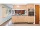 Retro kitchen with light wood cabinets and built-in oven at 11012 N Oregon Ave, Tampa, FL 33612