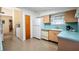 Retro kitchen with light blue countertops and wood cabinets at 11012 N Oregon Ave, Tampa, FL 33612