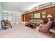 Spacious living room with brick accent wall and vintage furniture at 11012 N Oregon Ave, Tampa, FL 33612