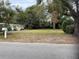 Large vacant lot with mature trees and street view at 11012 N Oregon Ave, Tampa, FL 33612