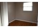 Simple bedroom with hardwood floors and a window with blinds at 11798 104Th St, Largo, FL 33773