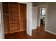 Bedroom with hardwood floors, neutral walls, and built-in shelving at 11798 104Th St, Largo, FL 33773