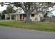 Single story home with a large tree in front at 11798 104Th St, Largo, FL 33773