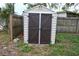 Tan and brown storage shed in backyard at 11798 104Th St, Largo, FL 33773