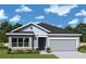 One-story home with gray siding, dark blue door, and two-car garage at 11853 Mile Marsh Dr, Riverview, FL 33569