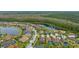 Aerial view of neighborhood with lake and houses at 12482 Wild Berry Trl, Odessa, FL 33556