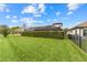 Landscaped backyard with lush lawn and privacy hedge at 12482 Wild Berry Trl, Odessa, FL 33556