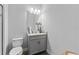 Small bathroom with toilet and gray vanity at 12482 Wild Berry Trl, Odessa, FL 33556