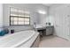 Spa-like bathroom with soaking tub, vanity, and gray cabinets at 12482 Wild Berry Trl, Odessa, FL 33556