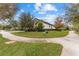 Single-Gathering home with a manicured lawn and decorative birds at 12482 Wild Berry Trl, Odessa, FL 33556