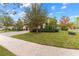 Single-Gathering home with a two-car garage and manicured lawn at 12482 Wild Berry Trl, Odessa, FL 33556