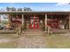 Inviting Anclote River Ranch storefront with red doors and rustic wood at 12482 Wild Berry Trl, Odessa, FL 33556