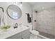 Modern bathroom with gray vanity, marble shower, and updated fixtures at 1300 S Hercules Ave # 12, Clearwater, FL 33764