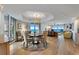 Bright dining area with ocean view and modern chandelier at 1310 Gulf Blvd # 4-G, Clearwater, FL 33767