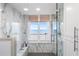 Large walk-in shower with marble walls and ocean view at 1310 Gulf Blvd # 4-G, Clearwater, FL 33767