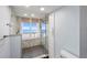 Walk-in shower with glass enclosure, marble finishes, and ocean view at 1310 Gulf Blvd # 4-G, Clearwater, FL 33767