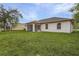 Spacious backyard with grassy lawn and screened patio at 1360 Franklin Ln, North Port, FL 34286