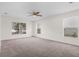 Spacious bedroom with neutral carpeting and ceiling fan at 1360 Franklin Ln, North Port, FL 34286